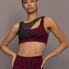 Model is wearing the Mesh Overlay Bra in Red Leopard, front view.