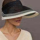 Model wears a black wide brim visor with white trim.