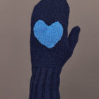 Close-up of indigo blue knit mitten with light blue heart patch, front view.