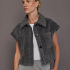 Model is wearing LUNE Sophie Vest in light grey melange with button front closure, spread collar, and boxy fit, front view.