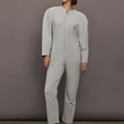 Model is wearing Bomber 1980s Zip Front Jumpsuit in Light Heather Grey, front view.