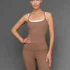 Model is wearing double layer melt tank caribou white, front upper body view.