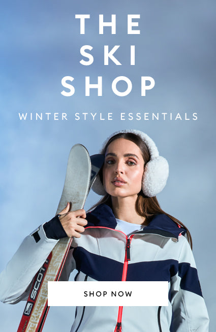 Model is wearing a navy and white ski jacket and navy ski pants. This image linking to the ski shop