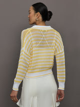 Model wears a lightweight collared open knit yellow and white striped sweater. 