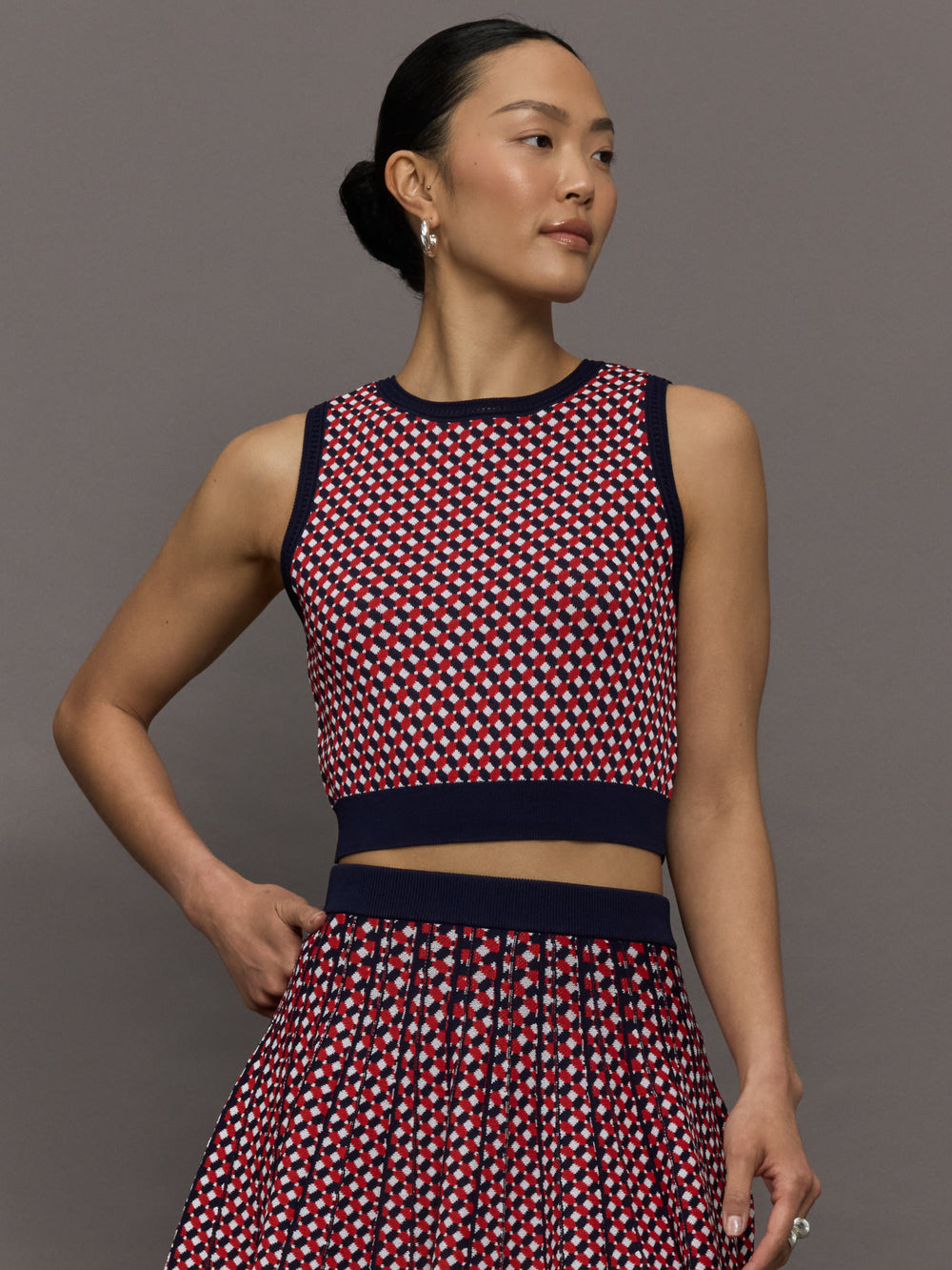 Model wears a red and blue patterned cropped tennis tank.
