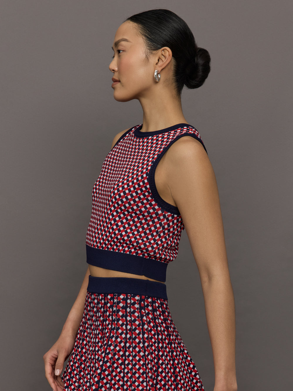 Model wears a red and blue patterned cropped tennis tank.