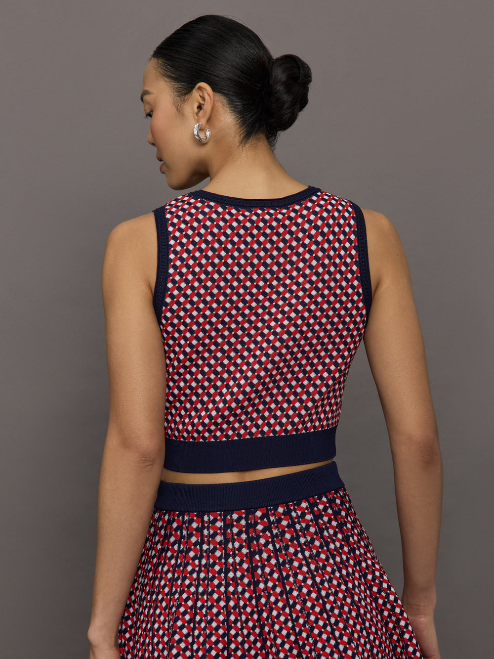 Model wears a red and blue patterned cropped tennis tank.