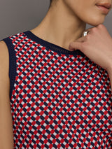 Model wears a red and blue patterned cropped tennis tank.