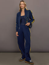 Model is wearing the Miaou pant in collegiate navy styled with the matching tracktop showing a coordinated athletic set.