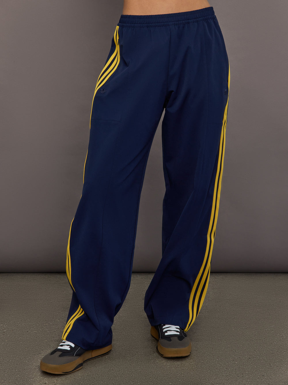 Front view of the Miaou pant in collegiate navy featuring a high rise elastic waistband and contrast stripe accents.