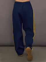 Back view of the Miaou pant in collegiate navy highlighting the fluid drape and relaxed athletic silhouette.