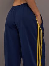 Detail view of the Miaou pant in collegiate navy highlighting the side pocket and contrast stripe construction.