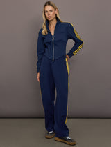 Model is wearing the Miaou tracktop in collegiate navy paired with matching track pants showing a streamlined athletic fit.