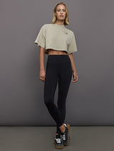 Model wears cropped t-shirt with a boxy fit, dropped shoulders, and a mock neck.
