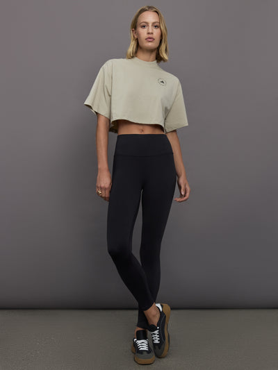 Model wears cropped t-shirt with a boxy fit, dropped shoulders, and a mock neck.
