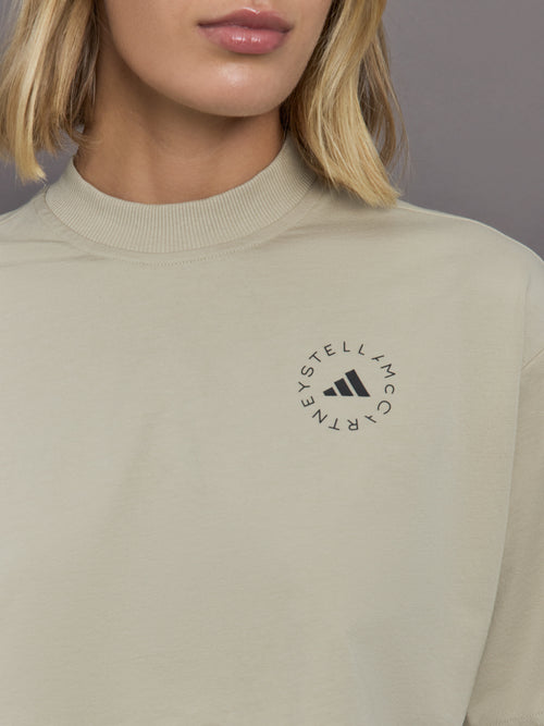 Model wears cropped t-shirt with a boxy fit, dropped shoulders, and a mock neck.
