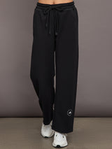 Model is wearing black sweatpants with drawstring and pockets