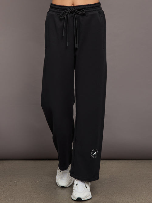 Model is wearing black sweatpants with drawstring and pockets