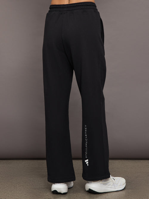 Model is wearing black sweatpants with drawstring and pockets