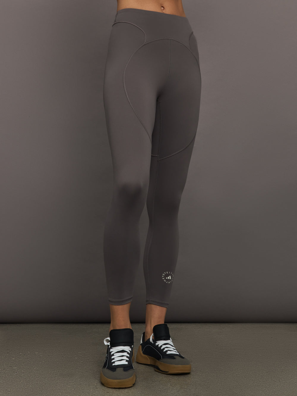 Model wearing gray leggings with a small logo.