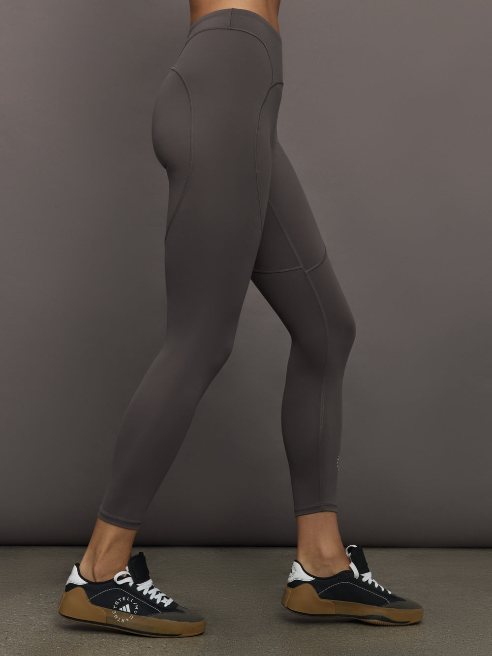 Model wearing gray leggings with a small logo.