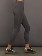 Model wearing gray leggings with a small logo.