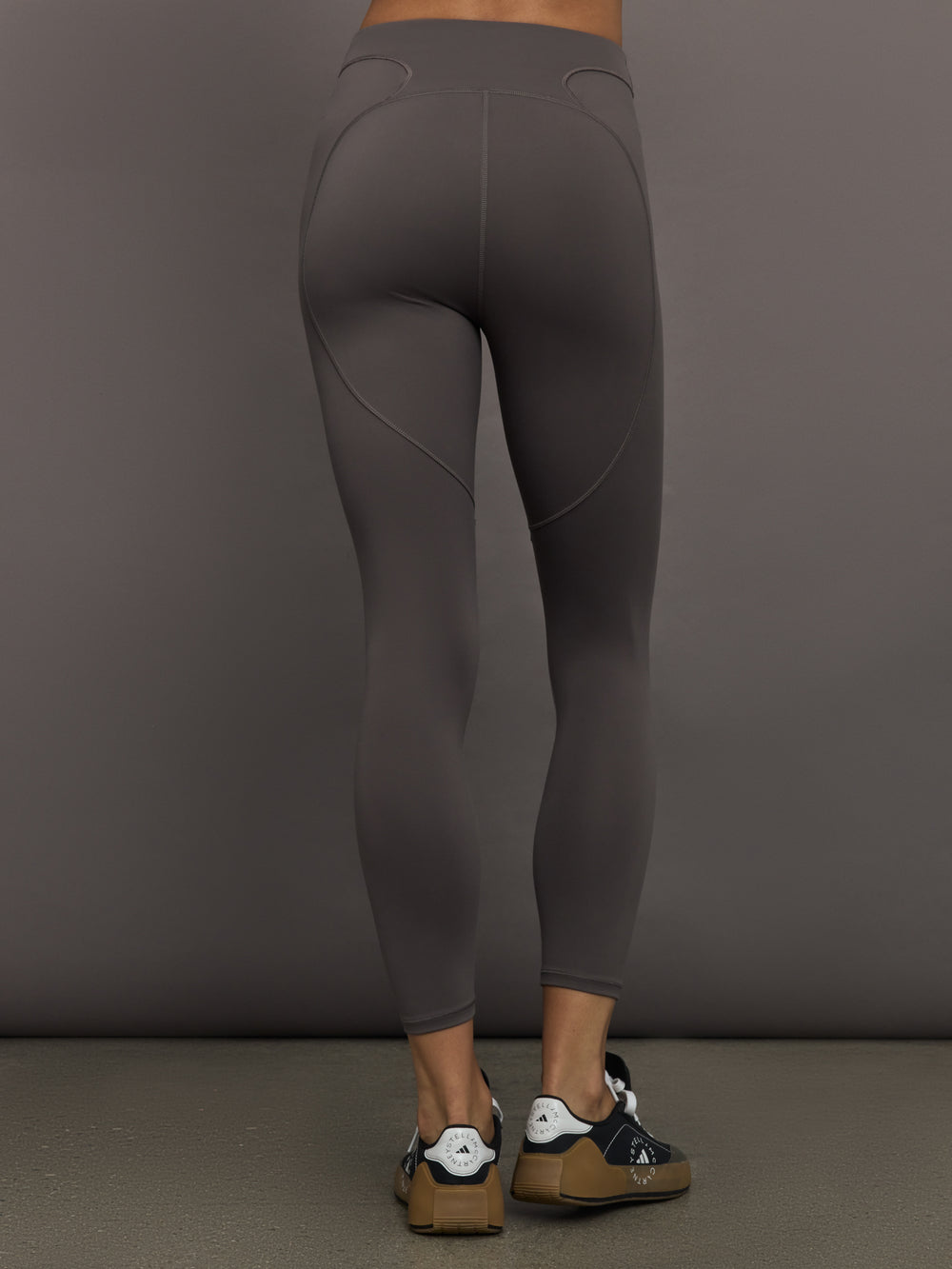 Model wearing gray leggings with a small logo.
