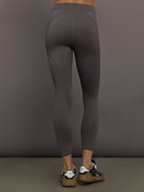 Model wearing gray leggings with a small logo.