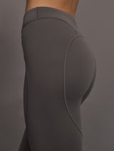 Model wearing gray leggings with a small logo.