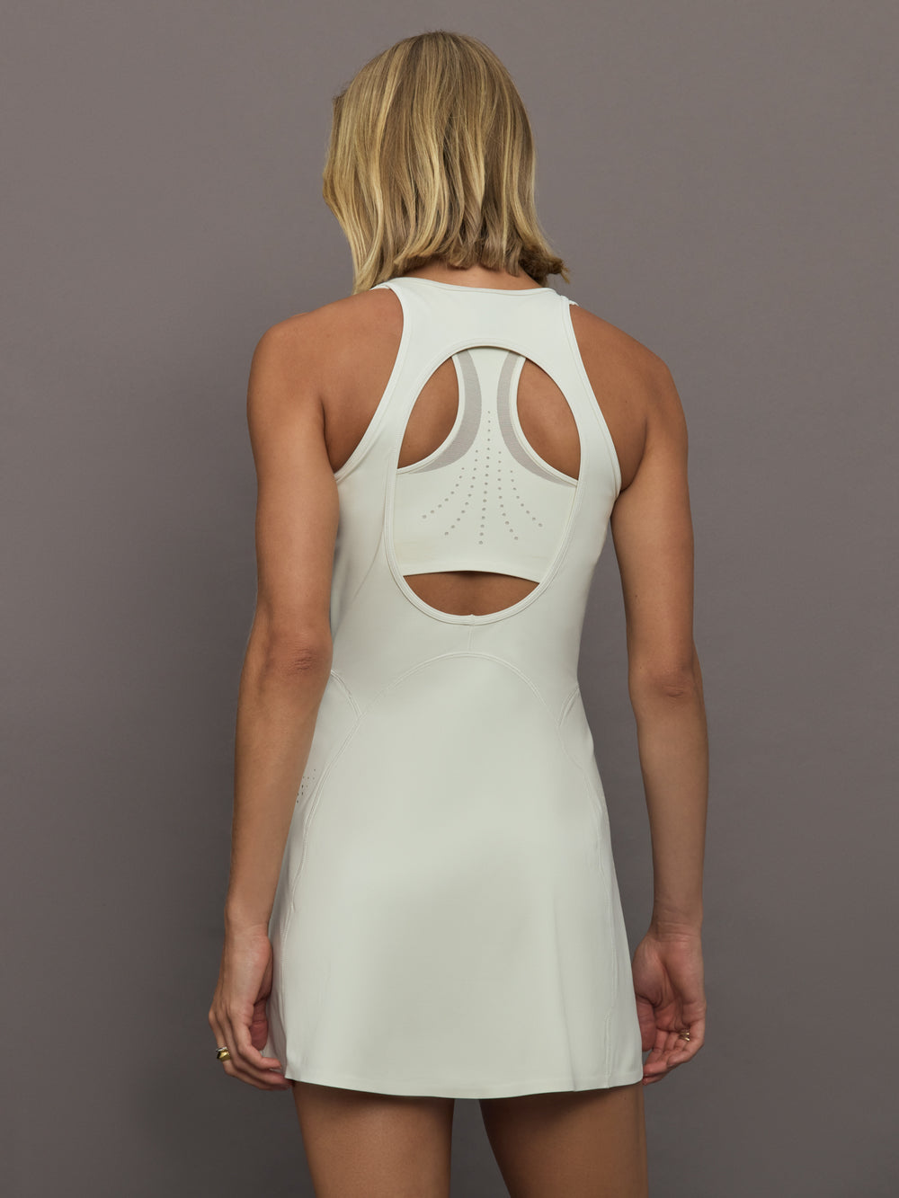 Model wearing a almond colored training dress.