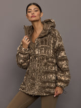 Woman wearing a patterned jacket against a gray background