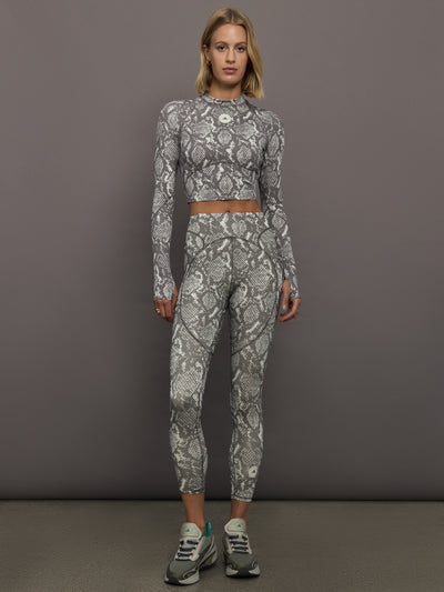 Model wearing grey and white snake print long-sleeve top.