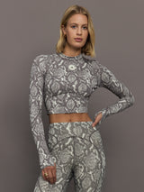 Model wearing grey and white snake print long-sleeve top.