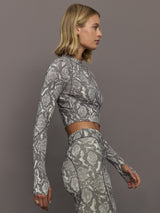 Model wearing grey and white snake print long-sleeve top.
