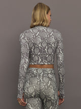 Model wearing grey and white snake print long-sleeve top.