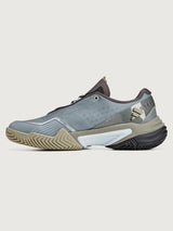 Gray and tan athletic shoe on a light gray background