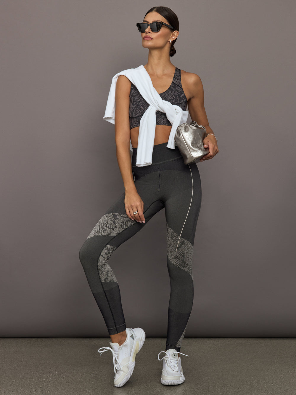 Woman in athletic wear with a gray background