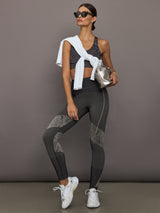 Woman in athletic wear with a gray background