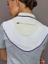 Person wearing a blue dress with Adidas and Stella McCartney logos.
