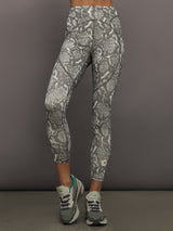 Model wearing grey and white snake print leggings.