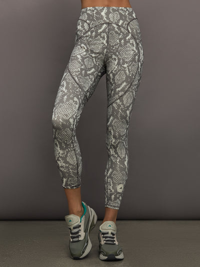 Model wearing grey and white snake print leggings.