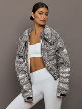 Model wears an almond/charcoal patterned jacket.