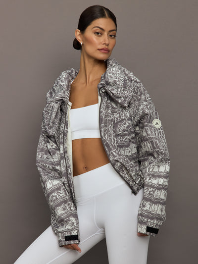 Model wears an almond/charcoal patterned jacket.