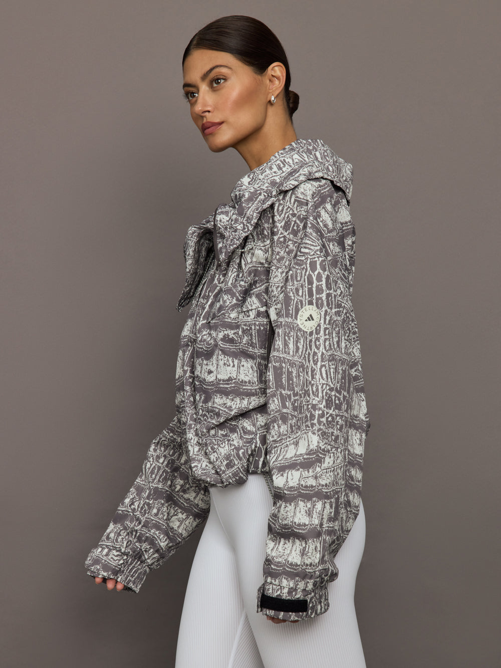 Model wears an almond/charcoal patterned jacket.