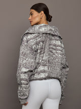 Model wears an almond/charcoal patterned jacket.