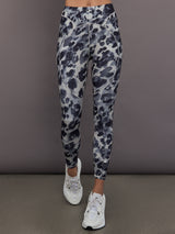 Model is wearing Training Interlock High-Waisted 7/8 Legging in Wonder Alumina/Black, front leg detail view.