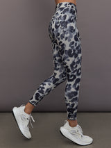 Model is wearing Training Interlock High-Waisted 7/8 Legging in Wonder Alumina/Black, side profile view.
