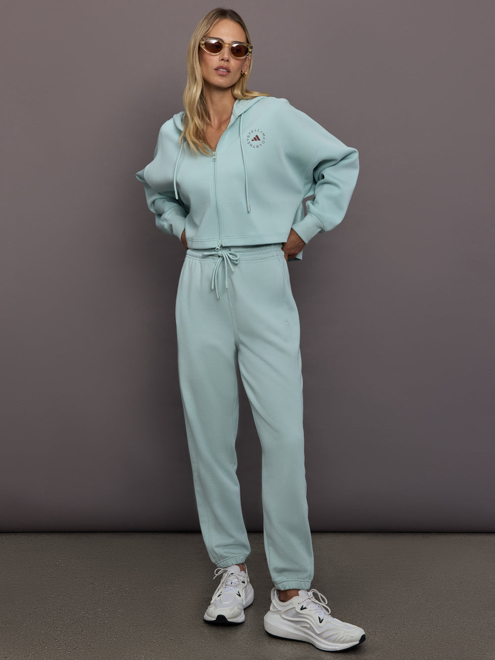 Model is wearing Sportswear Cropped Zip Hoodie in Vapour Green, full body styling.