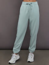Model is wearing Sportswear Regular Sweatpant in Vapour Green, front view.