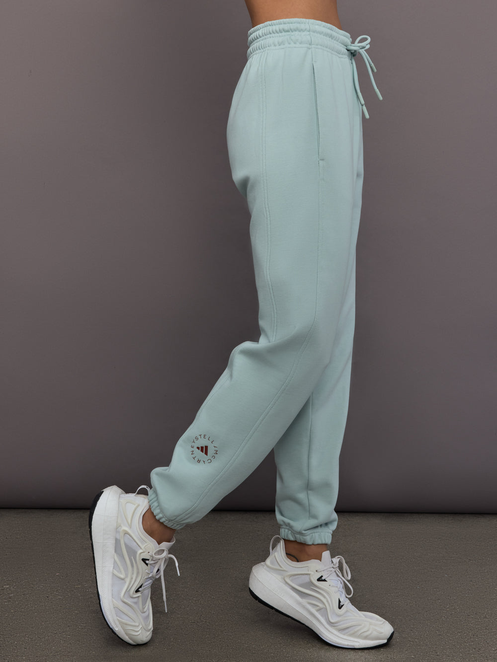 Model is wearing Sportswear Regular Sweatpant in Vapour Green, side view.